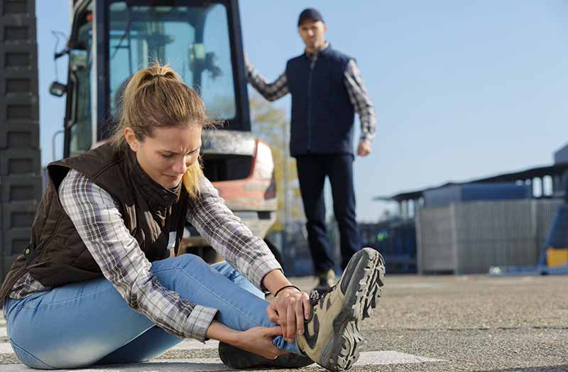 Woman holding her foot after a work injury